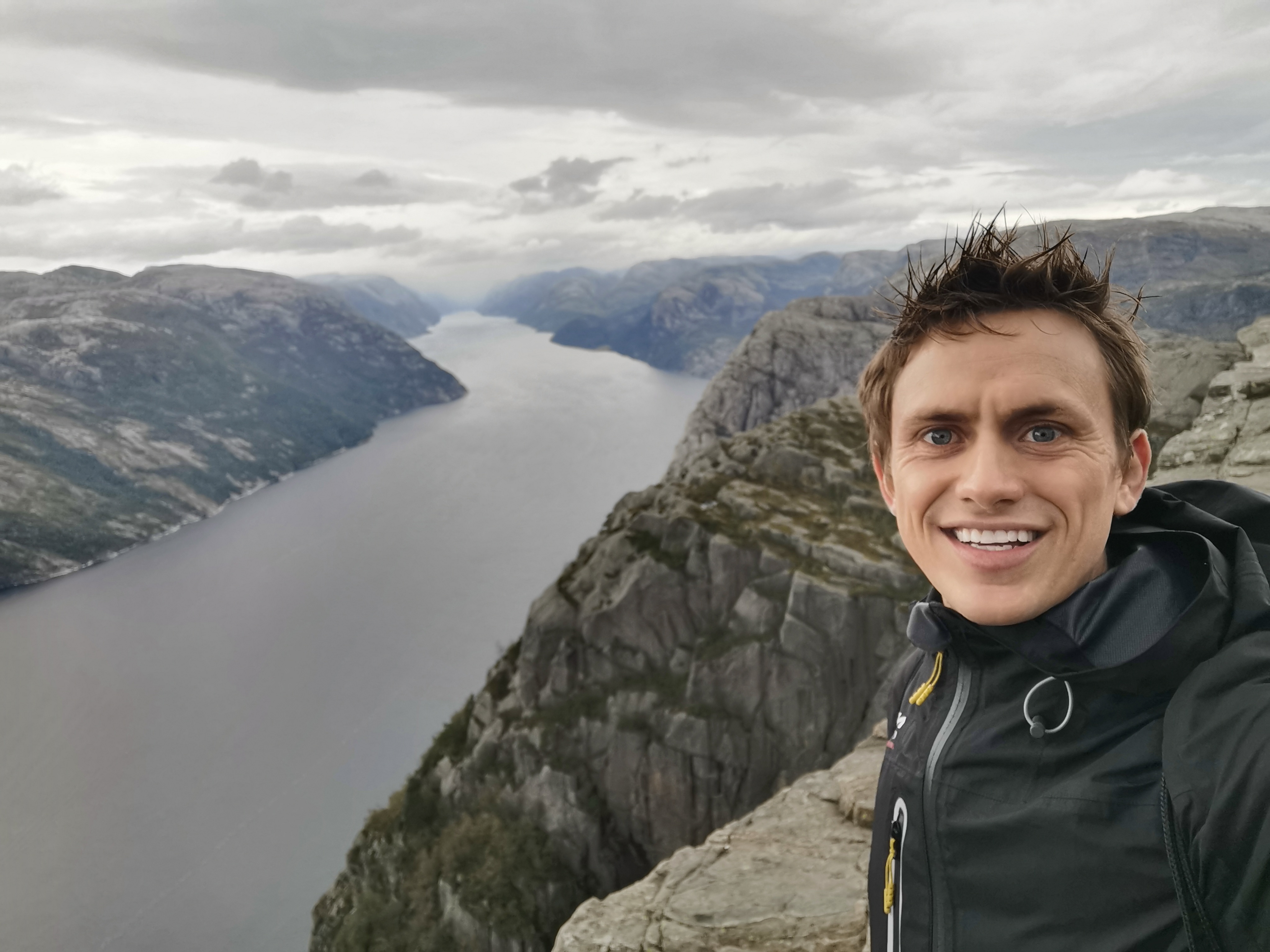 Self-shot portrait of Danny overlooking a fjord