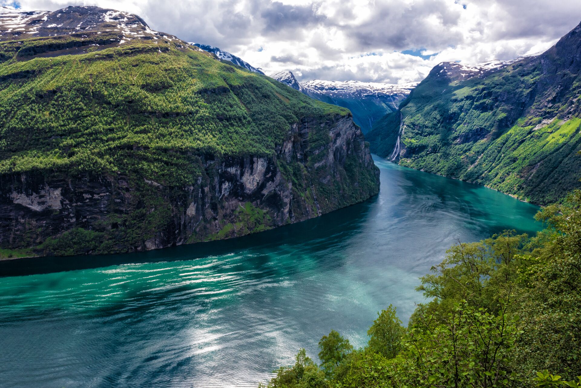 View overlooking Gerainger Fjord in Norway, with dappled sunlight on the water 