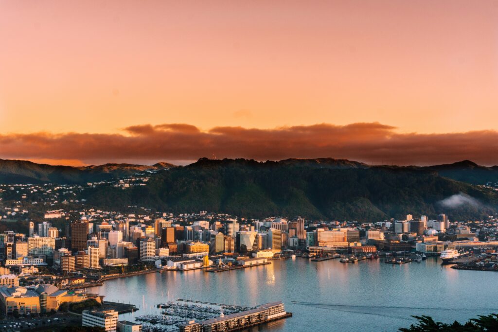 Tall buildings IN Wellington New Zealand beside the harbour at sunset