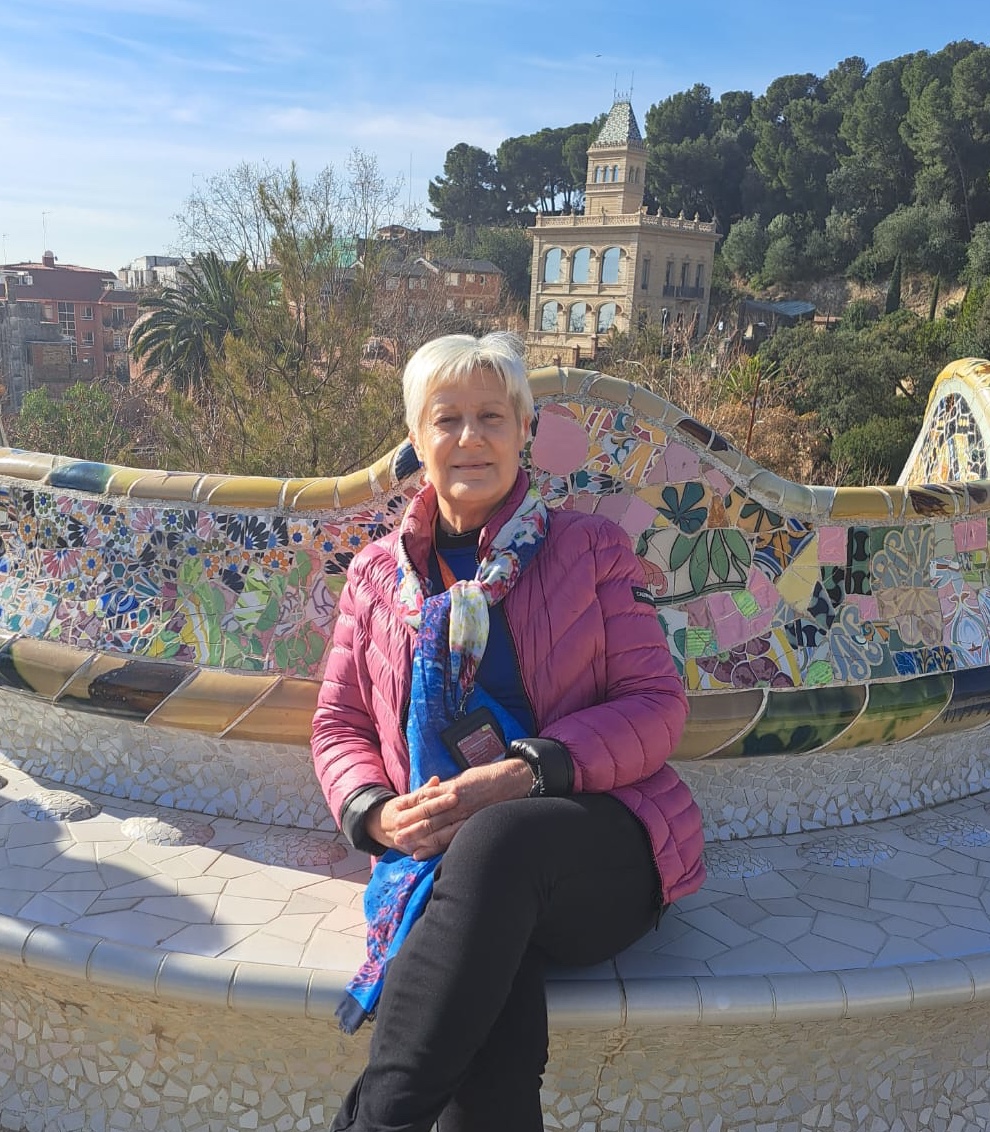 Travel Director Amada sits on an ornate bench in Park Guell, on one of the most famous Gaudi Barcelona works