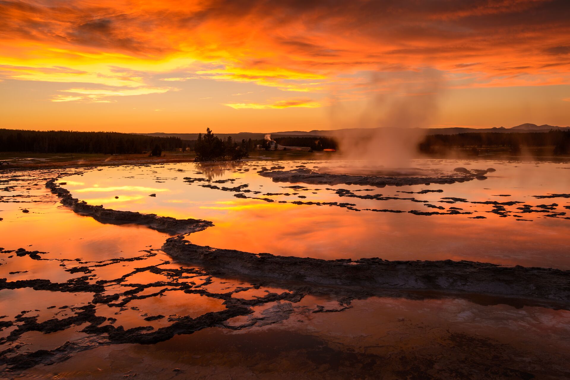 Steam rises in the sunset at the hot springs in Yellowstone National Park