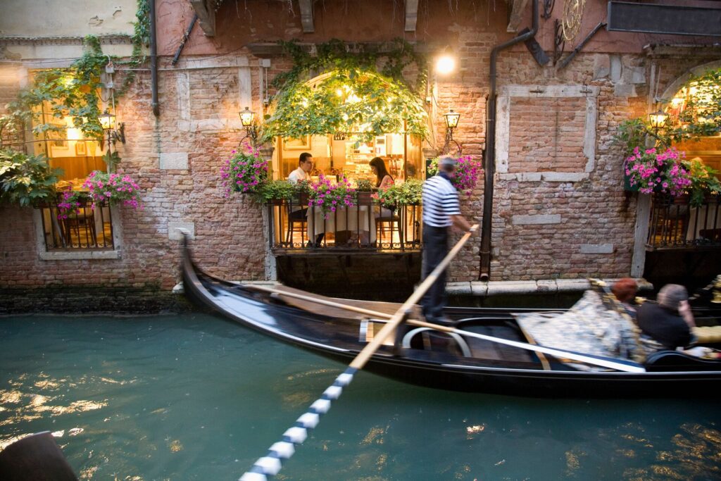 The gondoliers of Venice gracefully navigate their iconic gondola through the enchanting canals of Italy's floating city.