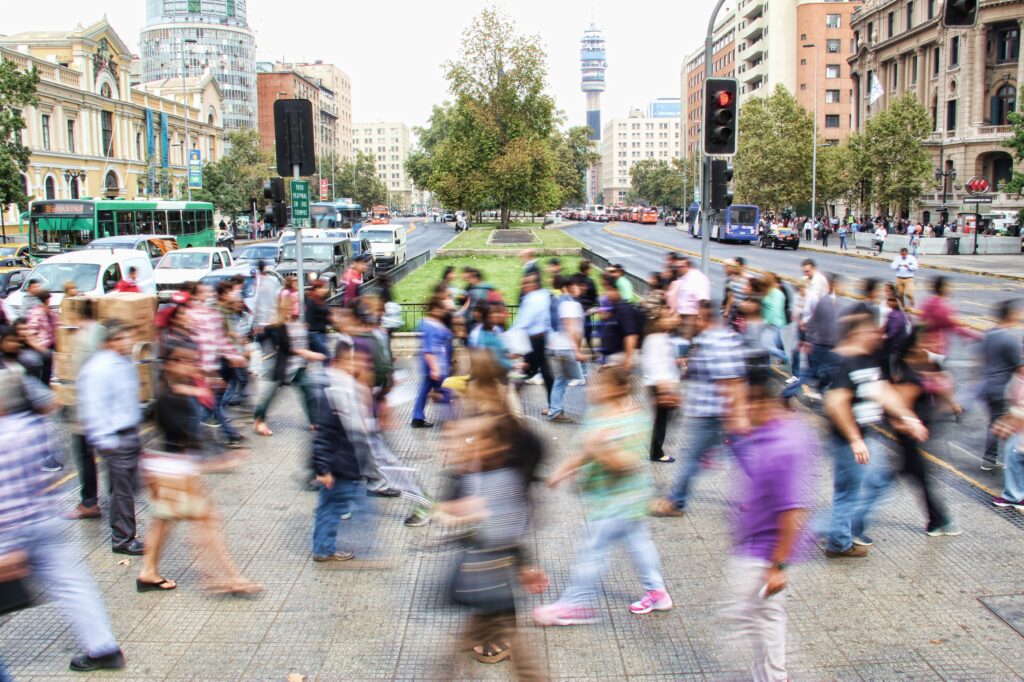 A blurry image of a crowd of people crossing a street in Venice.