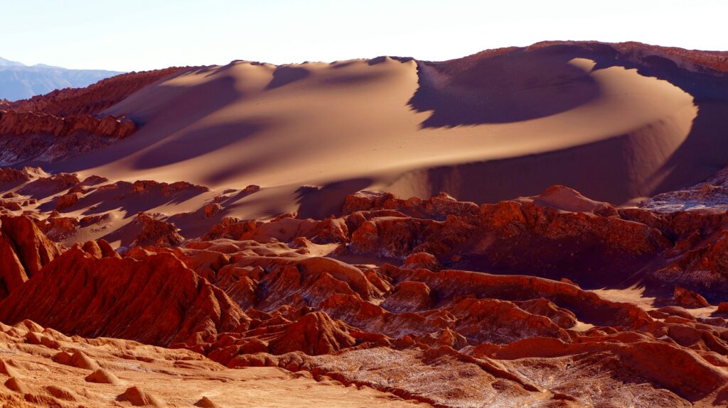 red-coloured sand dune and sculptural rocks feature in Chile's Moon Valley