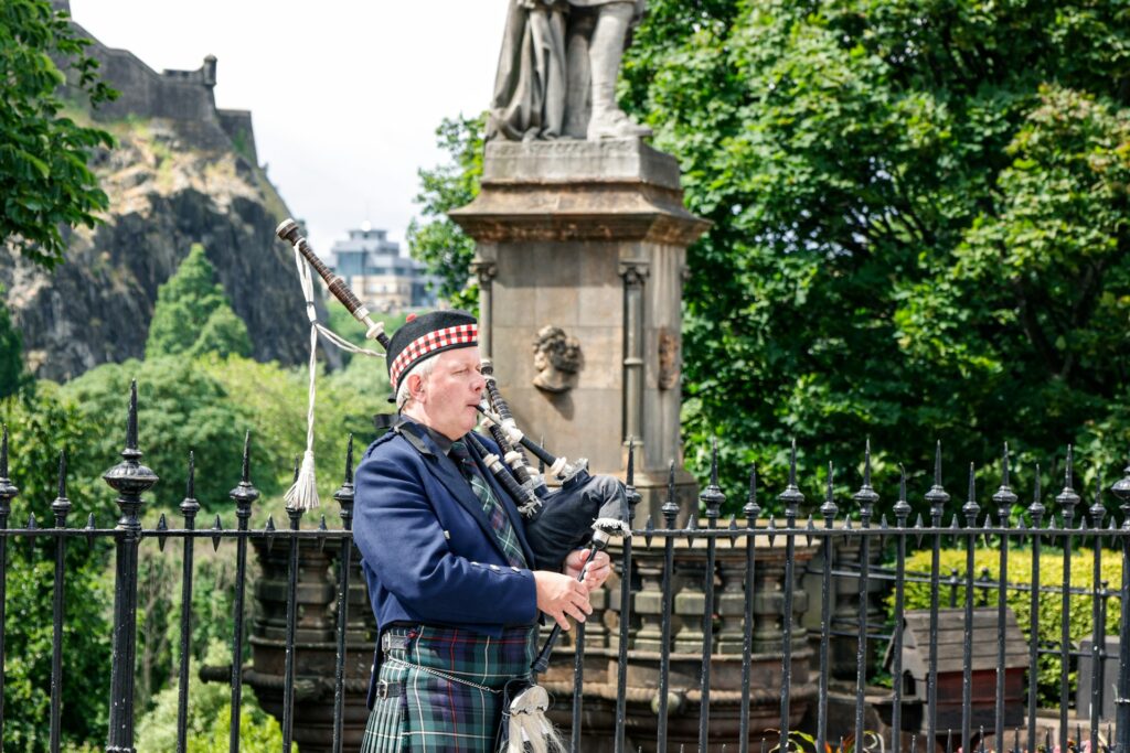 Bagpiper playing the bagpipes near Edinburgh castle