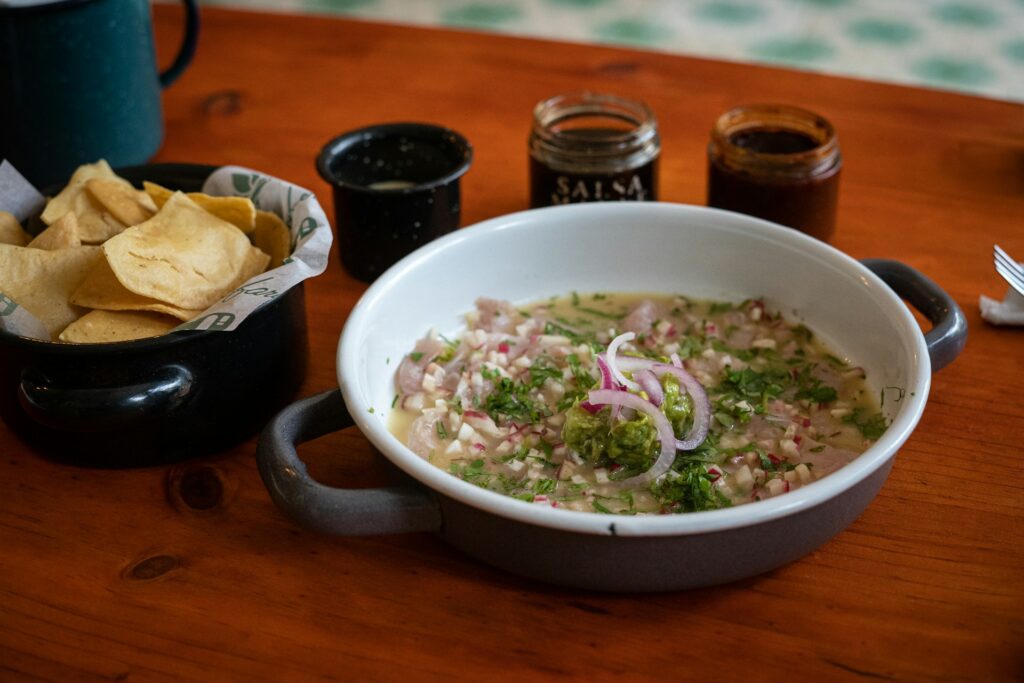 Table with a bowl of ceviche and tortilla chips 