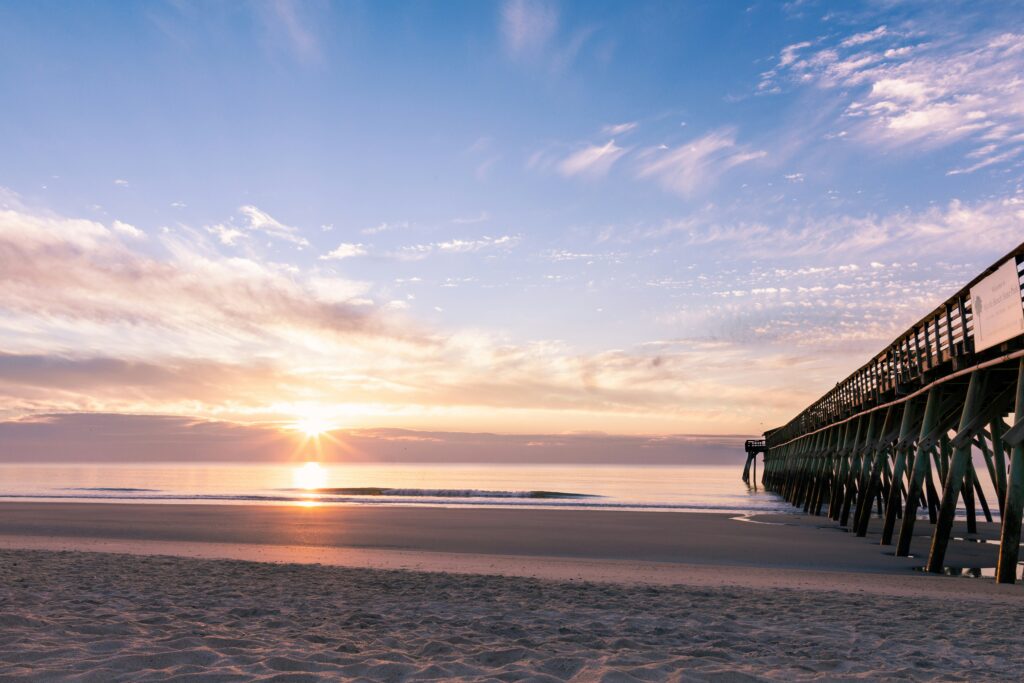 Sunrise view of beach with pink sky