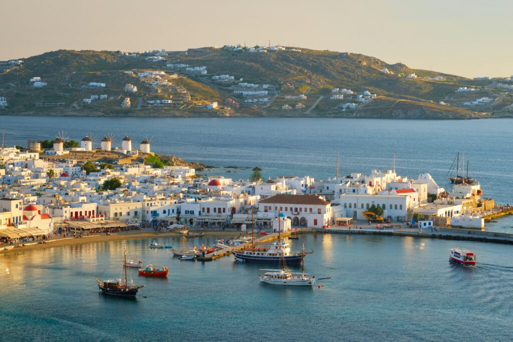 A Greek town and harbour with and island behind