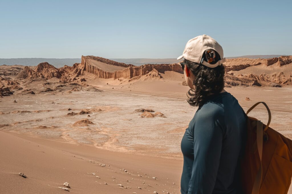 Woman standing looking out towards desert landscape