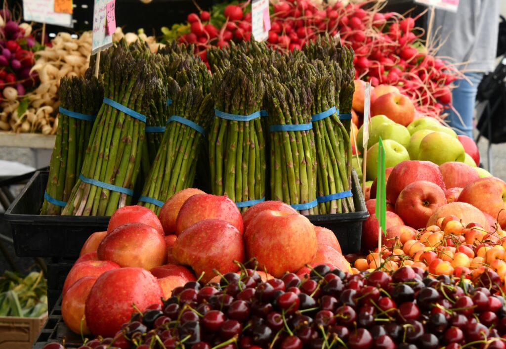 asparagus and apples at a farmer's market