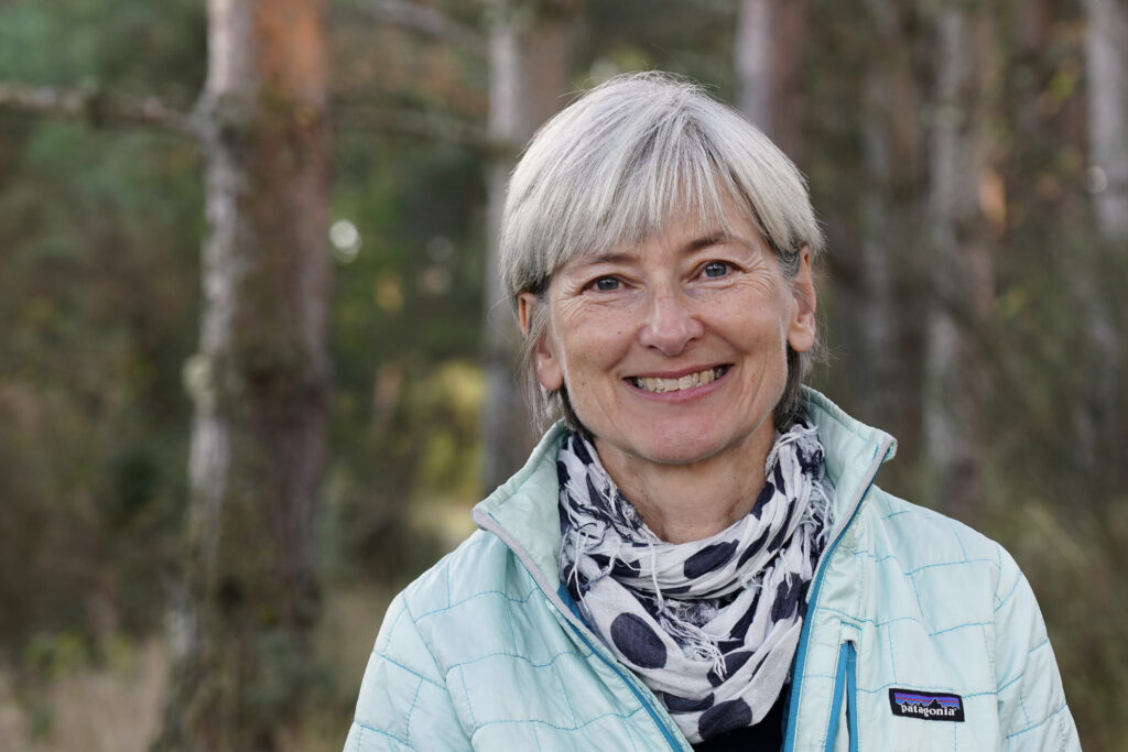 A portrait fo Sarah from Trees for Life in a forrest.