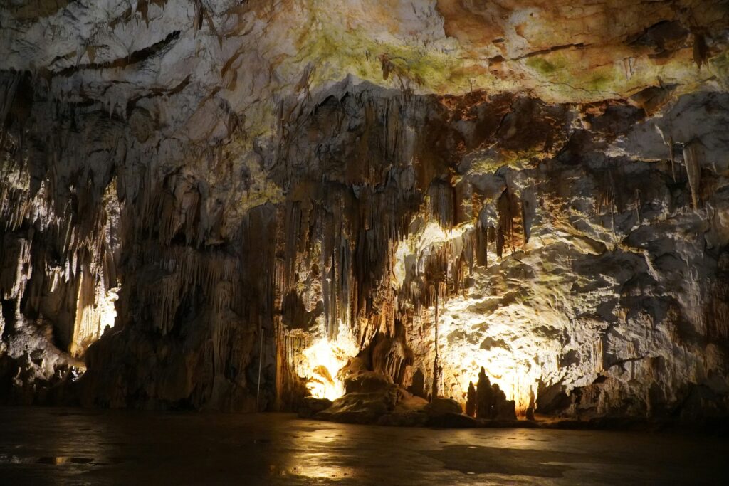 Stalagmites hang from the ceiling of a Postojna Cave in Slovenia