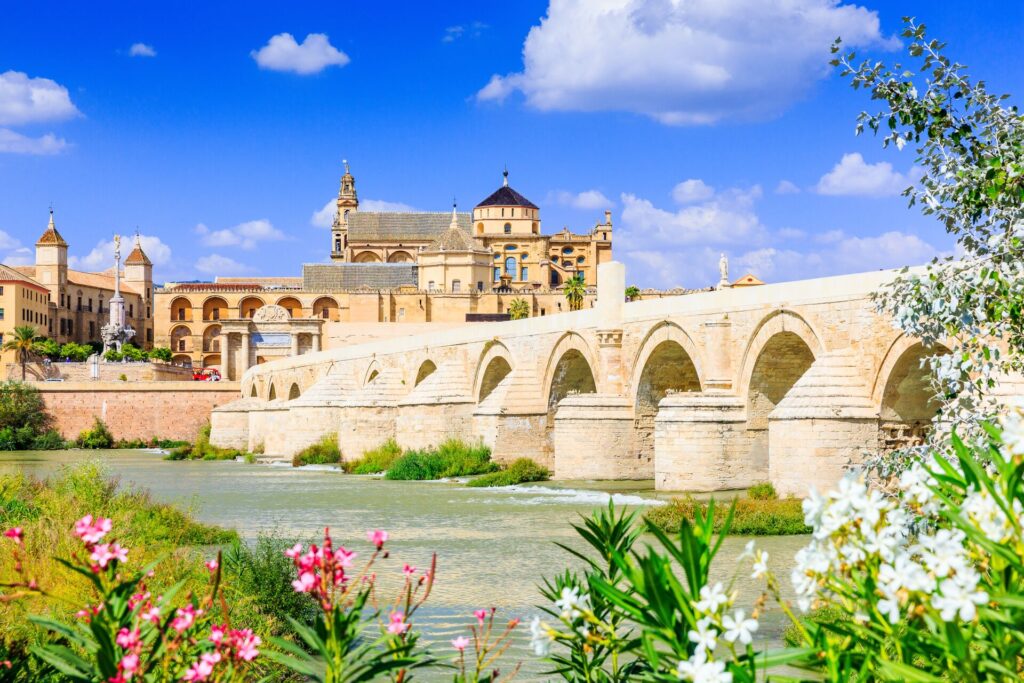 View across a river to a white stone palace in Spain