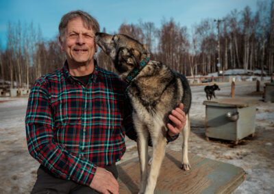 Martin Buser with a husky at Happy Trail Kennels