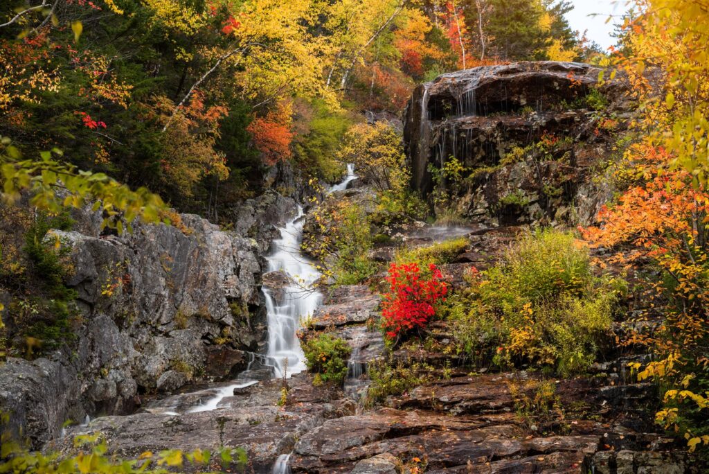 A waterfall and autumn colours in New England in the fall