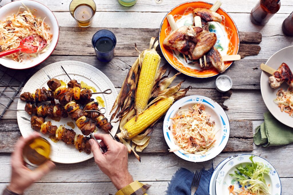 A BBQ spread laid out on a wooden table