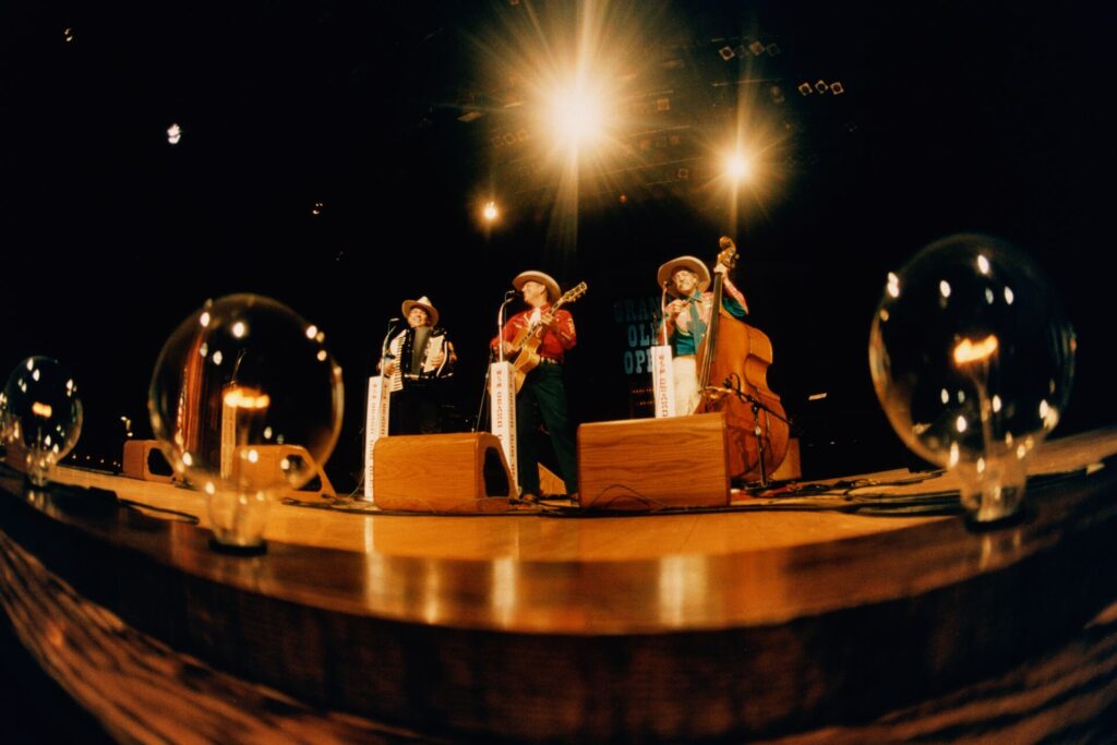 Trio of performers on stage at the Grand Ol Opry in Nashville, USA.