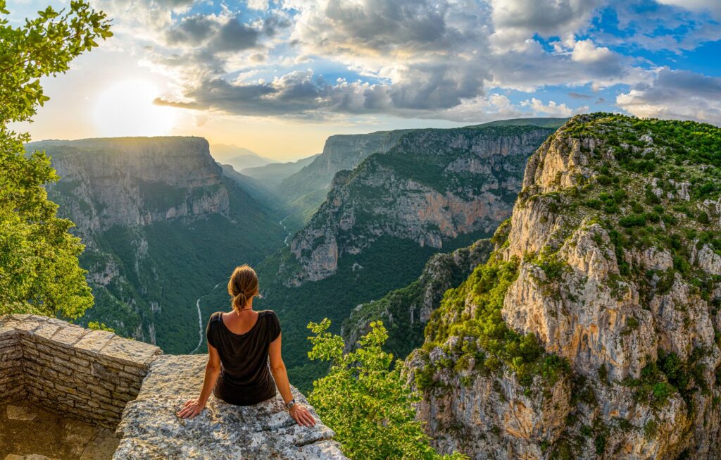 woman enjoying the view of Vikos canyon in Greece