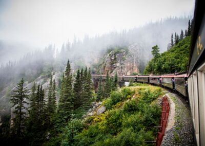 Alaskan railway travels through forests and mountains in Alaska