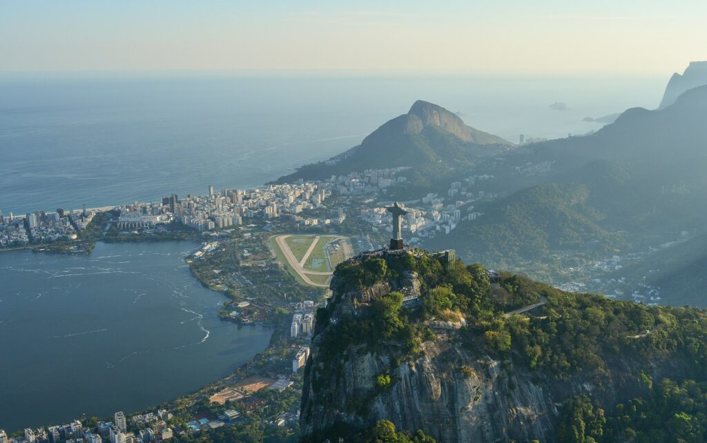 Wide angle view of Christ the Redeemer statue looking over the shoreline of Rio de Janeiro