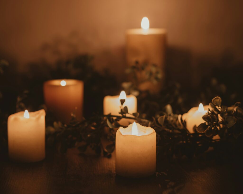 lit candles and foliage