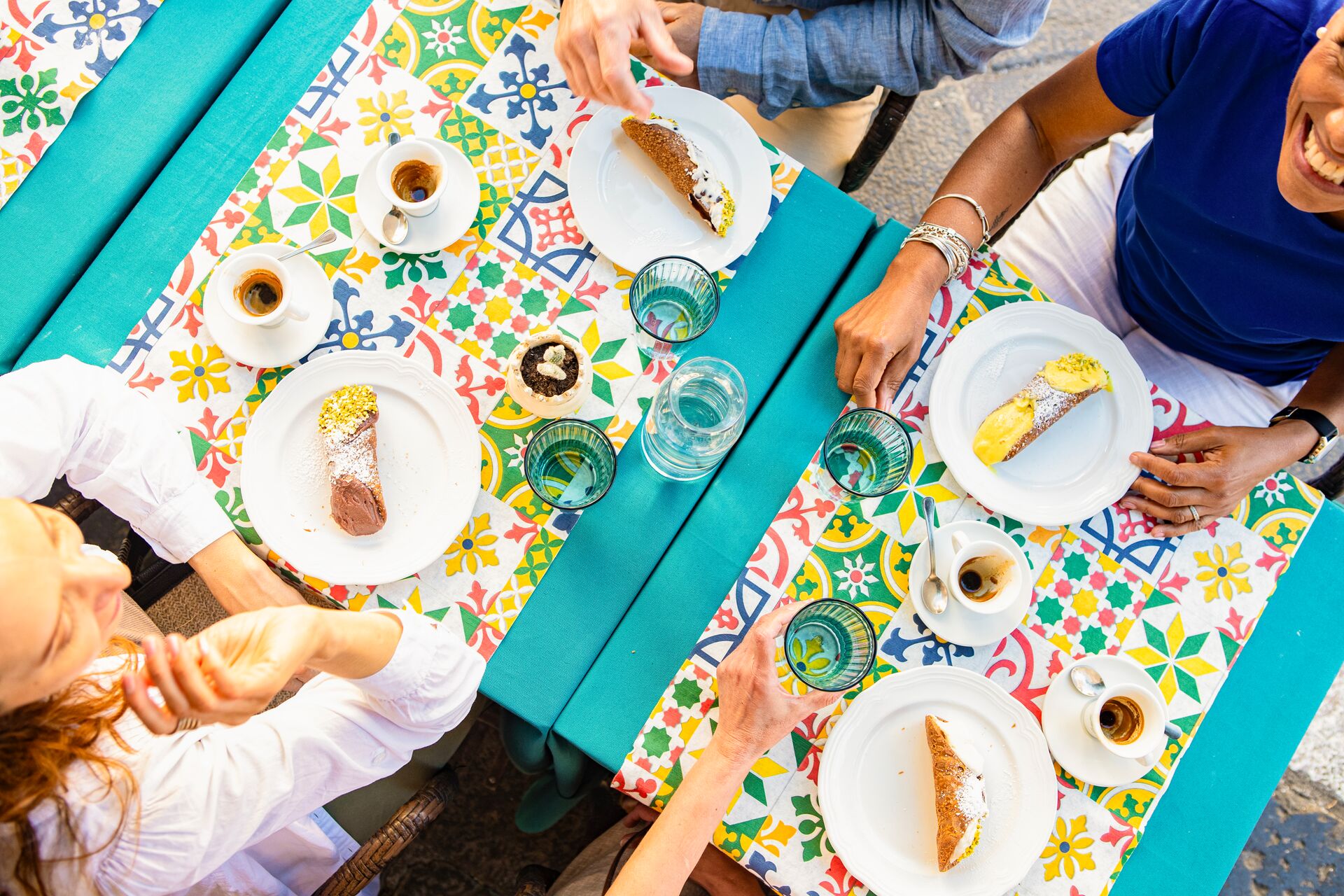Guests enjoying Cannoli and coffee at a cafe in Taormina, Italy