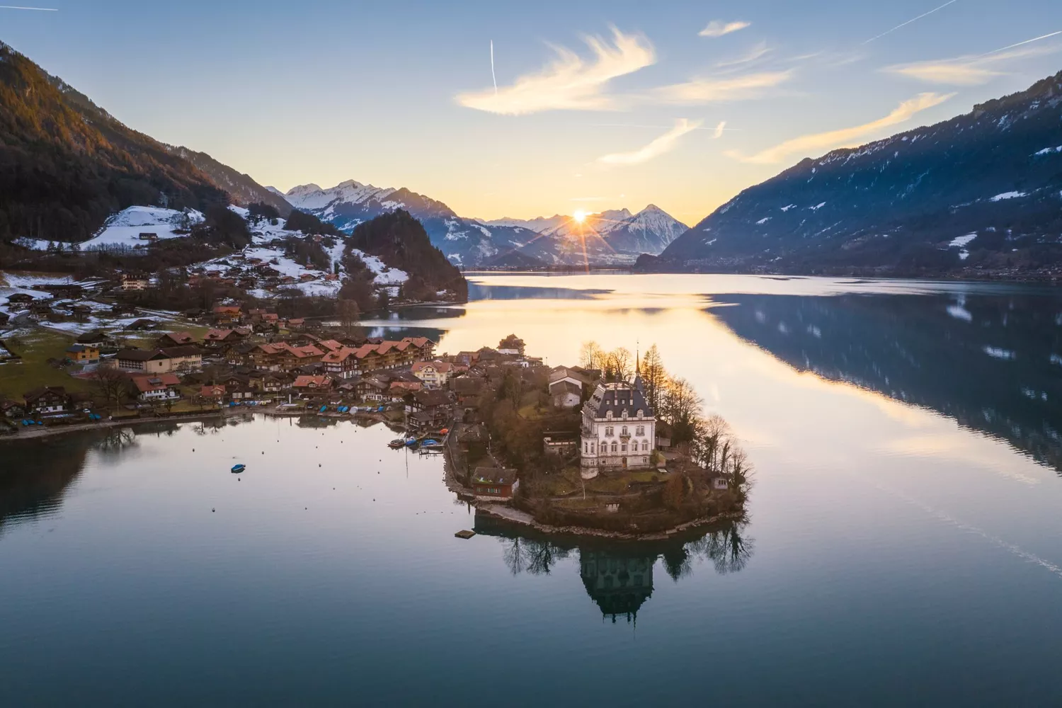 Iseltwald at Sunset in Switzerland with the snowy mountains behind it