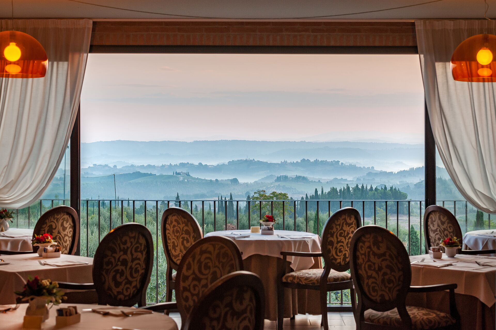 The restaurant in Villasanpaolo Wellness Spa Hotel in San Gimignano, Italy with the Tuscan hills in the background