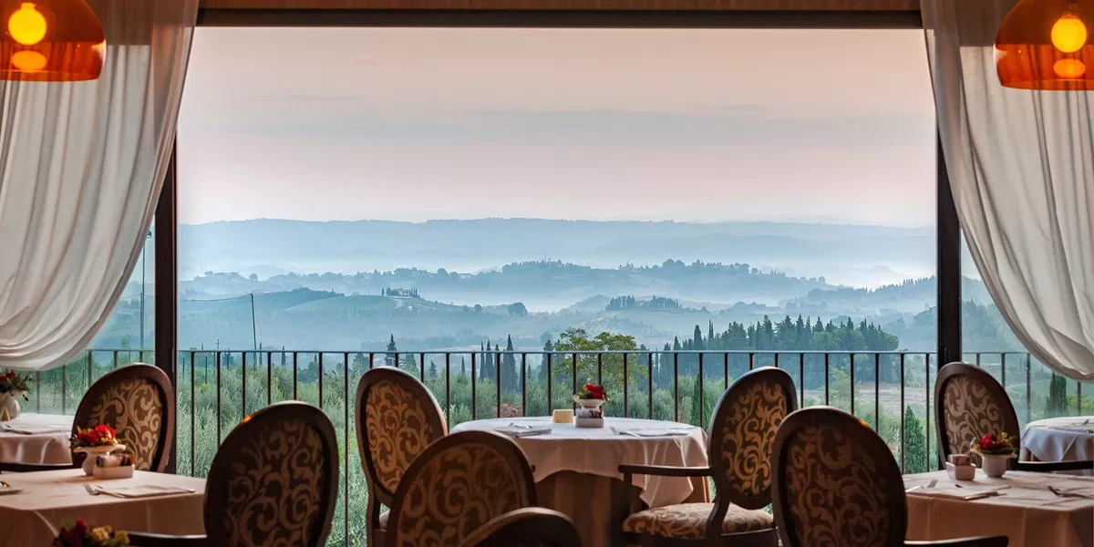The restaurant in Villasanpaolo Wellness Spa Hotel in San Gimignano, Italy with the Tuscan hills in the background