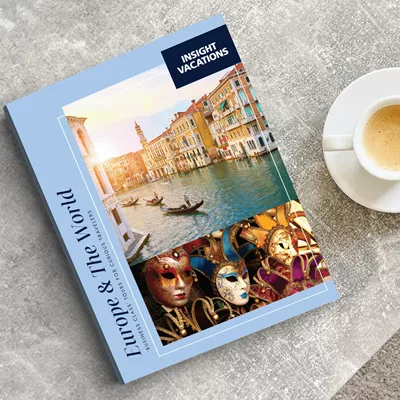 Insight Vacations brochure on table next to a cup of coffee