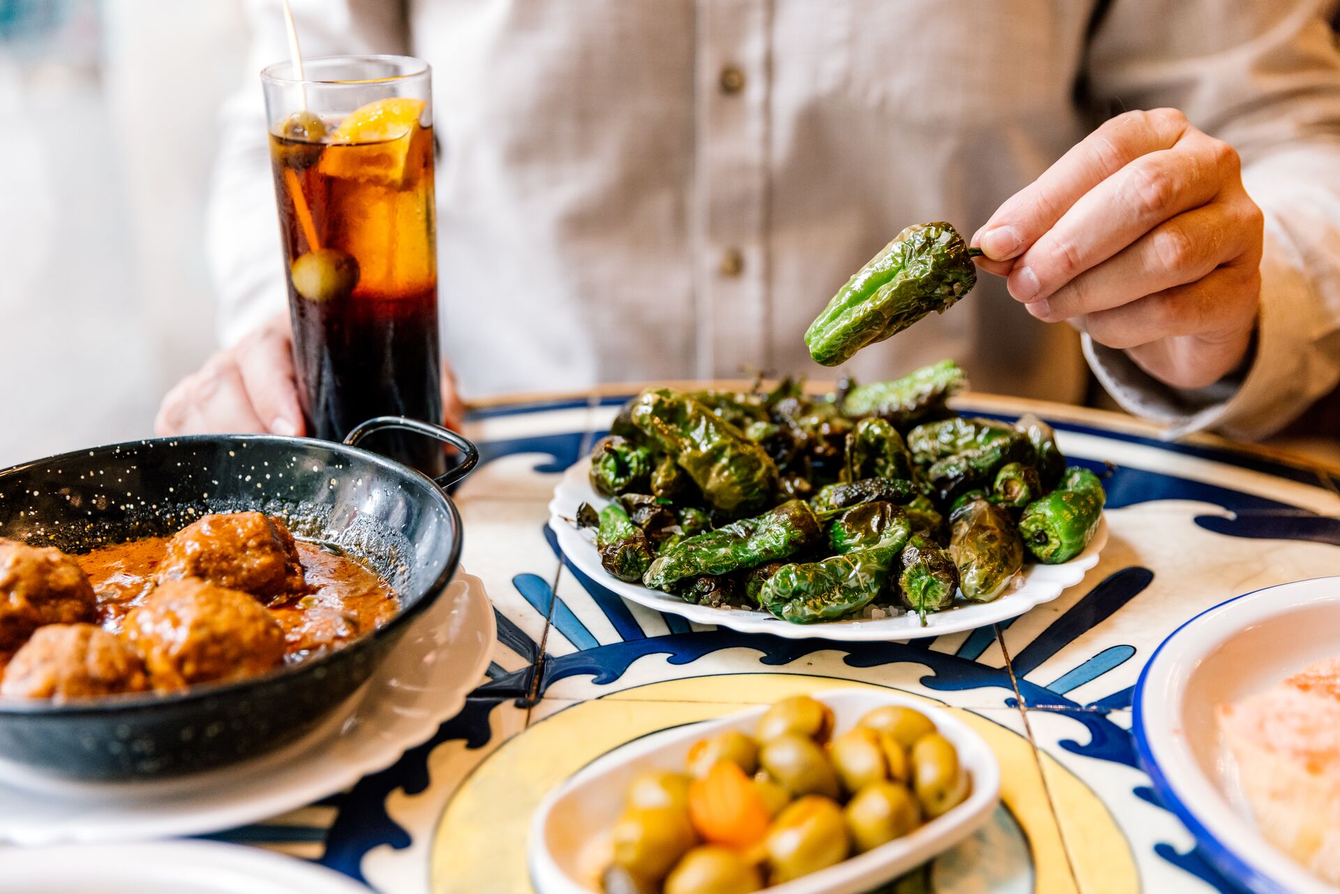Man Eating Fried Green Bell Peppers in a Tapas Bar in Barcelona, Spain