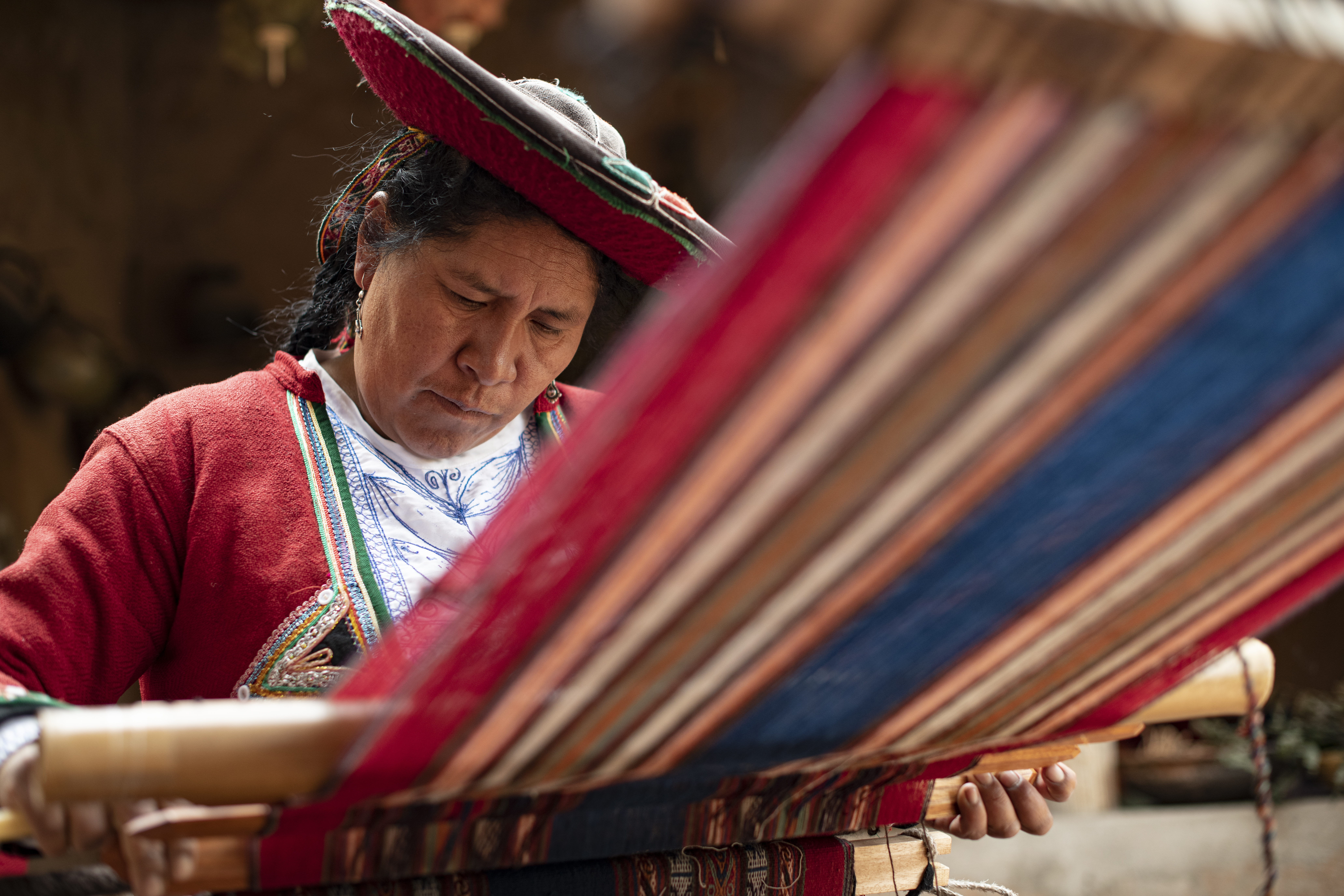Woman doing traditional textile weaving in Peru