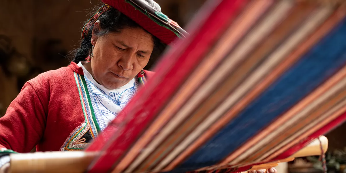 Woman doing traditional textile weaving in Peru