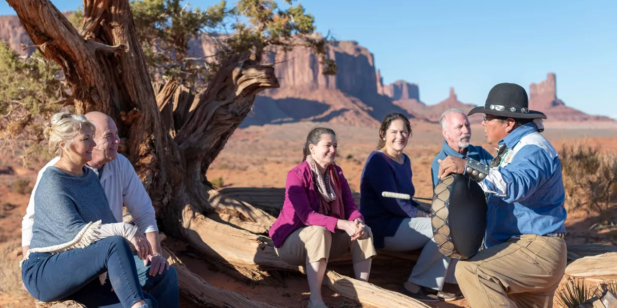Navajo guide talking to a group of tourists in Monument Valley, USA