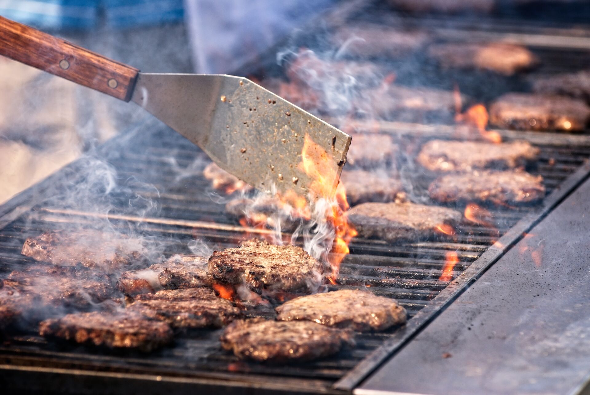 Hamburgers being grilled over an open flame