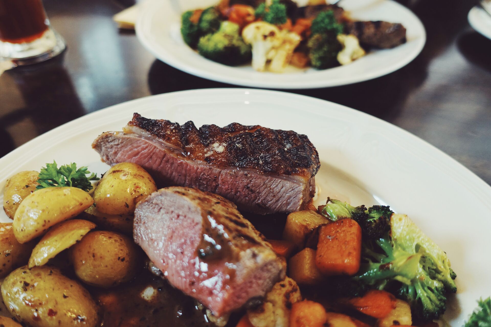 Roasted Lamb Steak Served With Grilled Vegetables And Potatoes