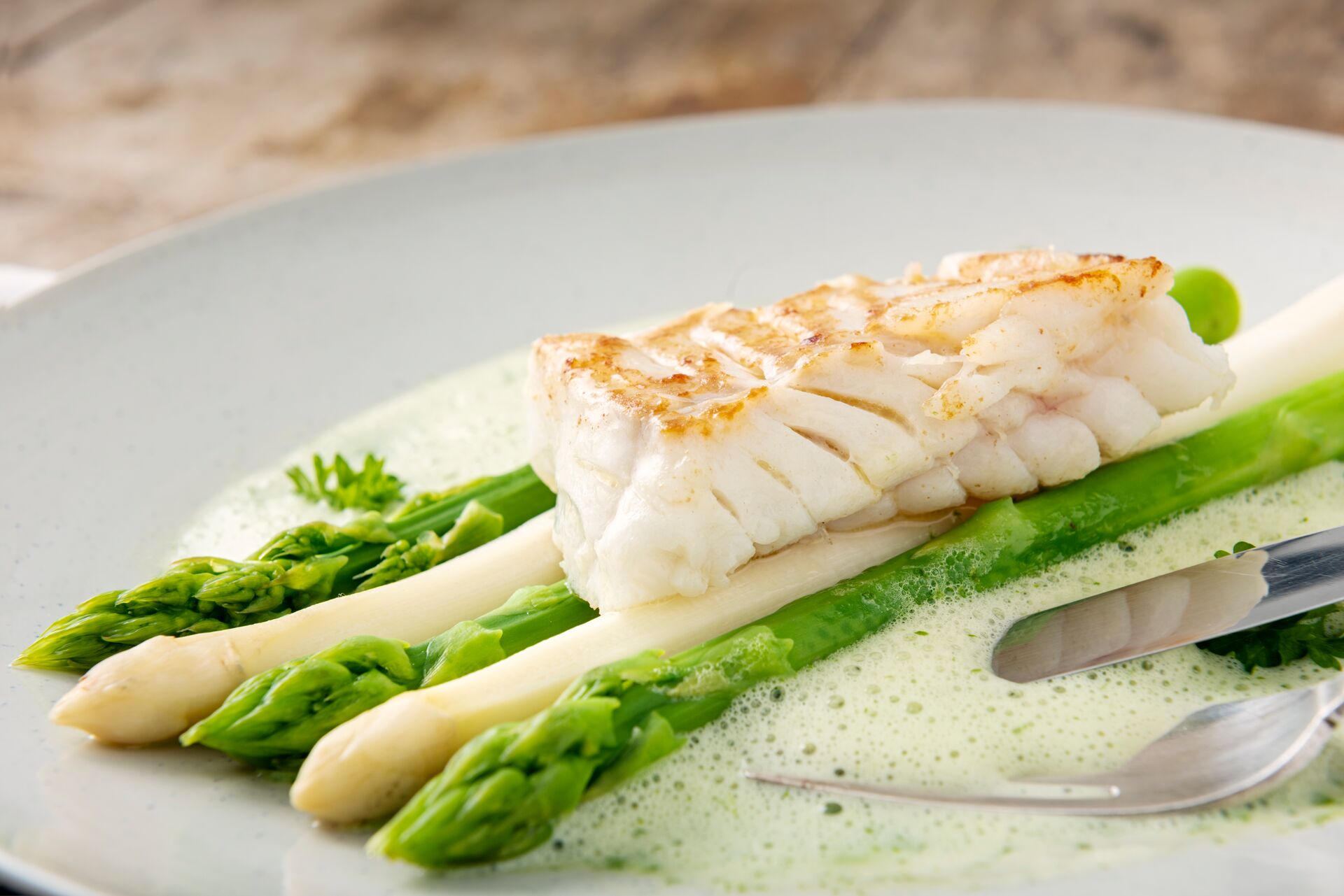 Close up image of a dish of Asparagus with cod