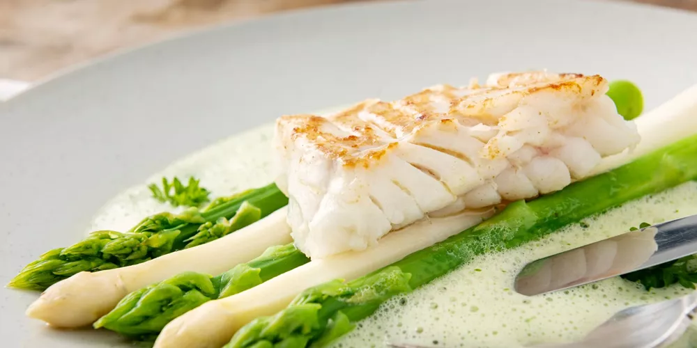 Close up image of a dish of Asparagus with cod