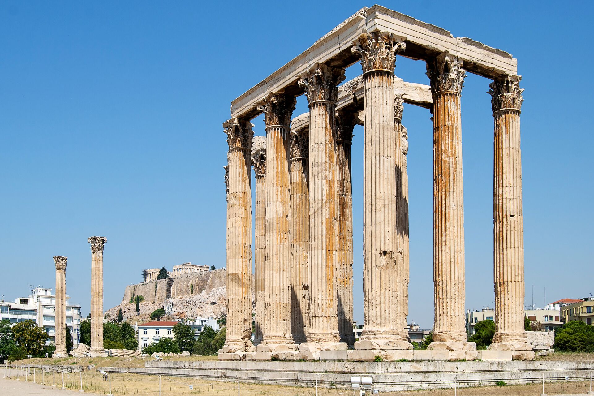 Temple Of Olympian Zeus with the Parthenon in the background in Athens, Greece