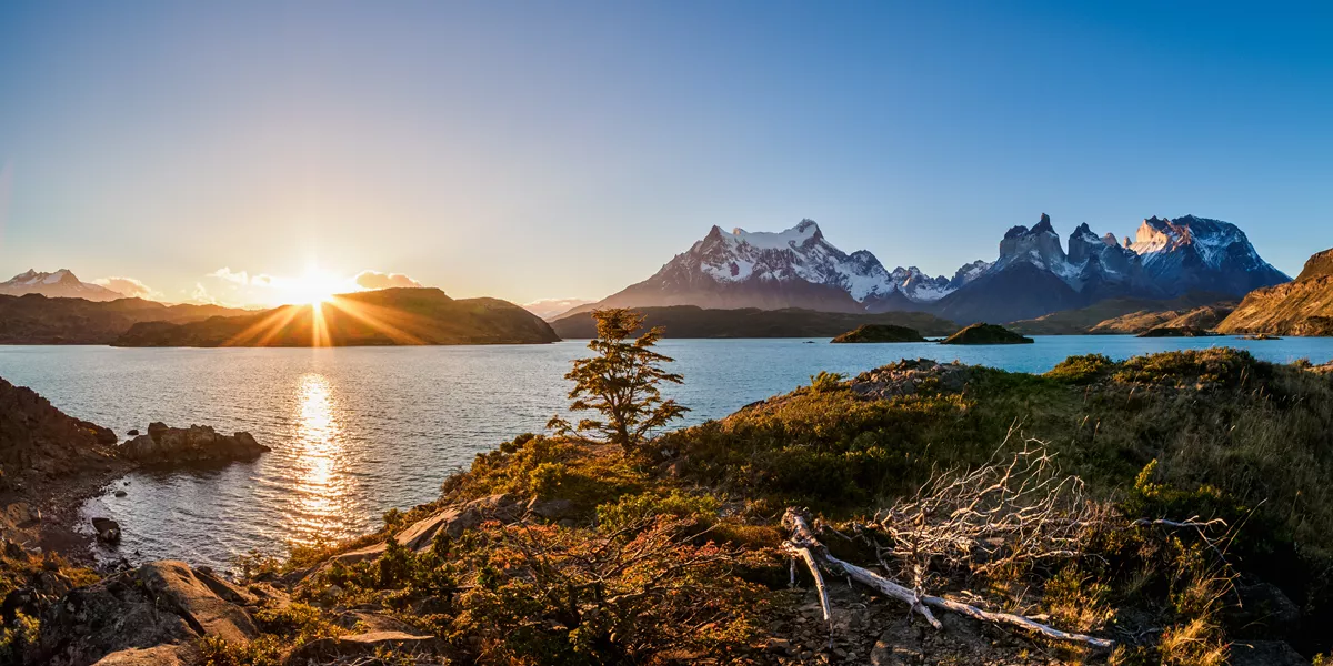 Beautiful sunset over a lake with snow-capped mountains in the background