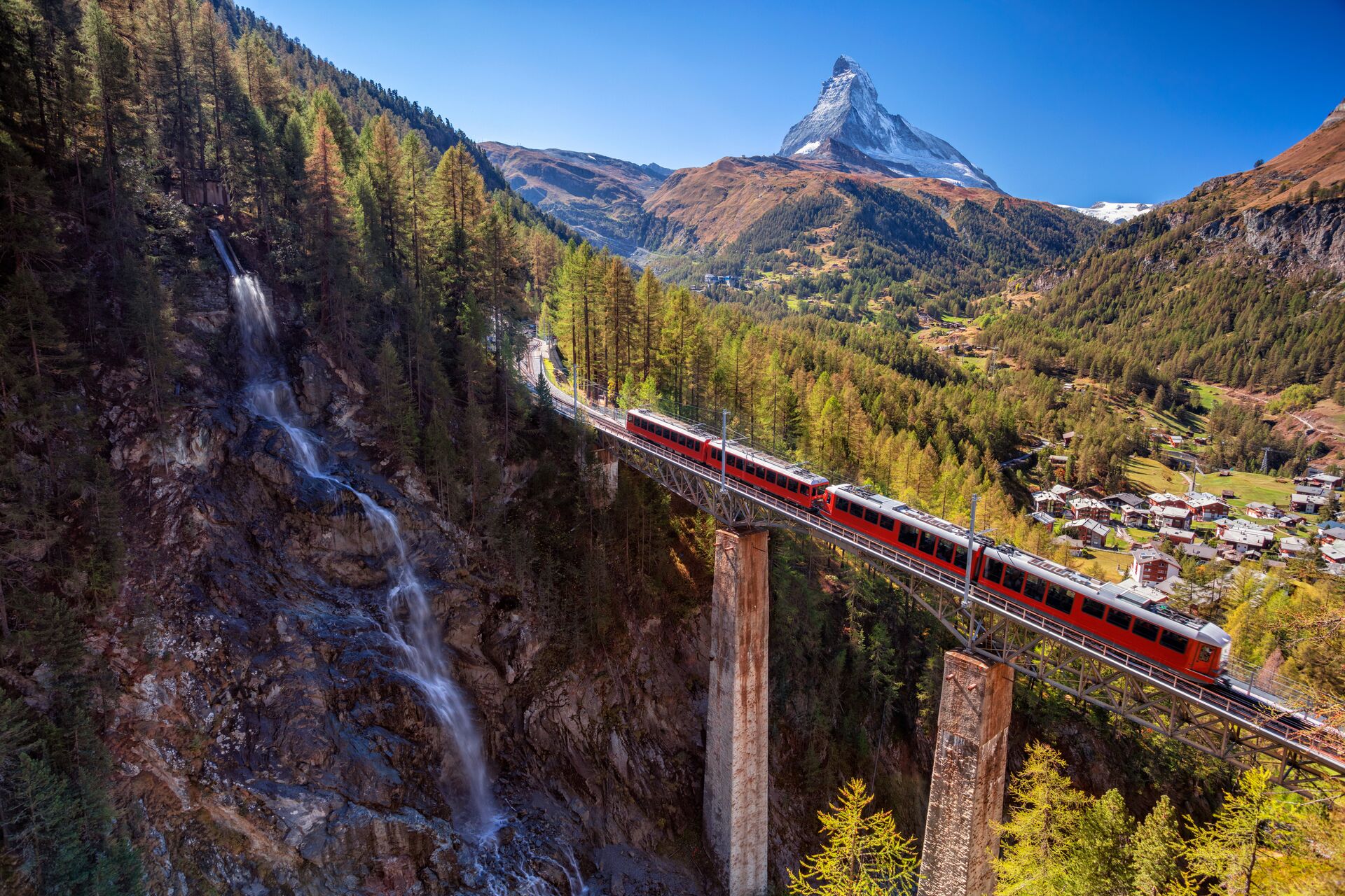 Glacier Express passing a waterfall with the Matterhorn in the background