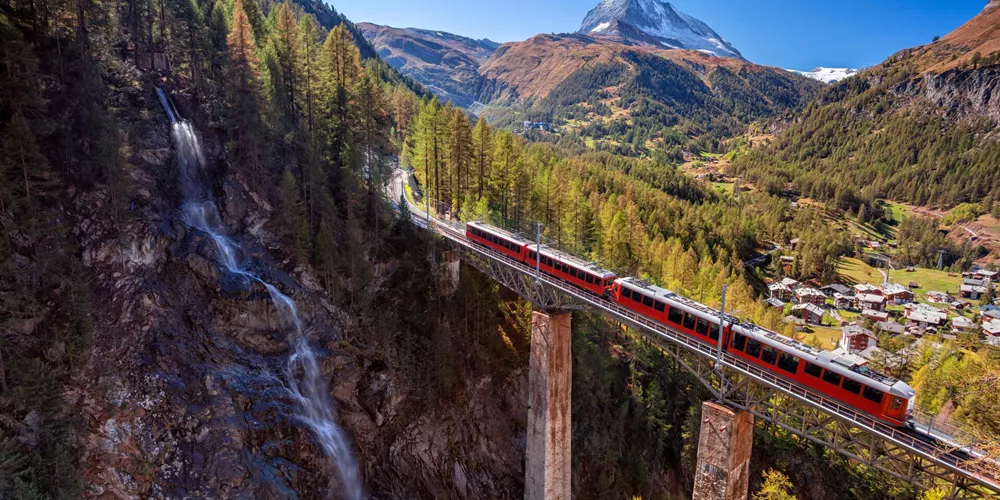 Glacier Express passing a waterfall with the Matterhorn in the background