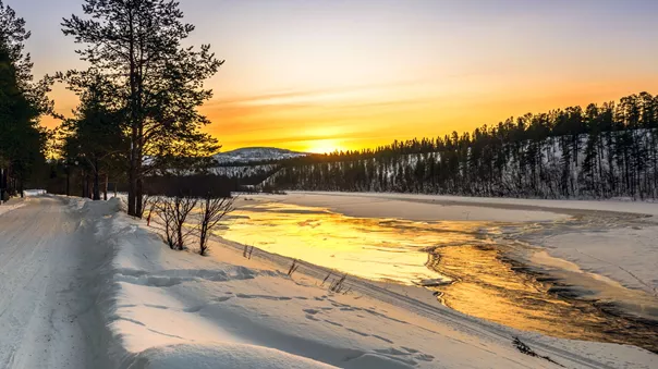 Sunrise on a lake in the arctic in Norway at winter