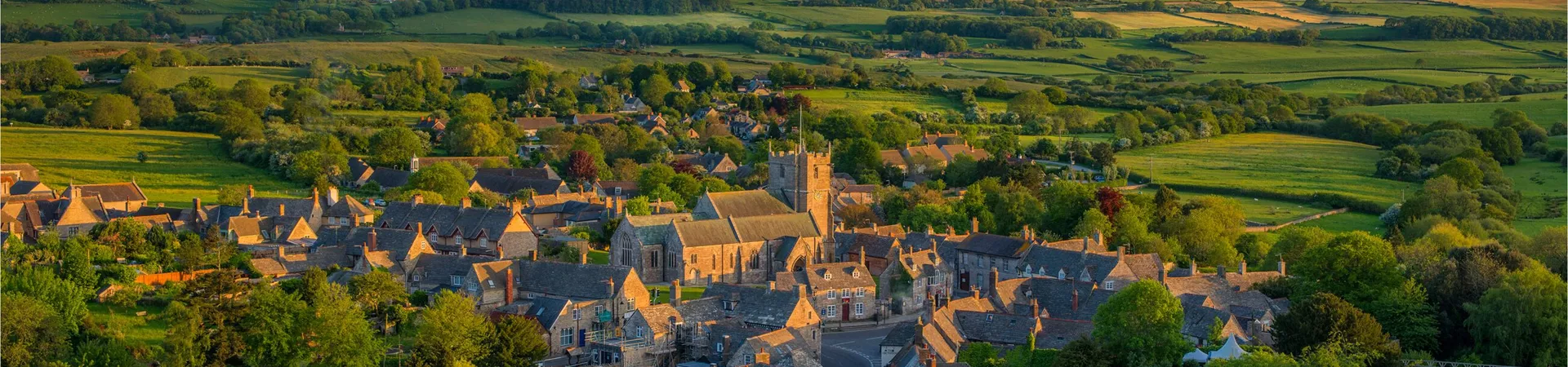 The traditional Corfe Village surrounded by fields in Dorset, England, UK