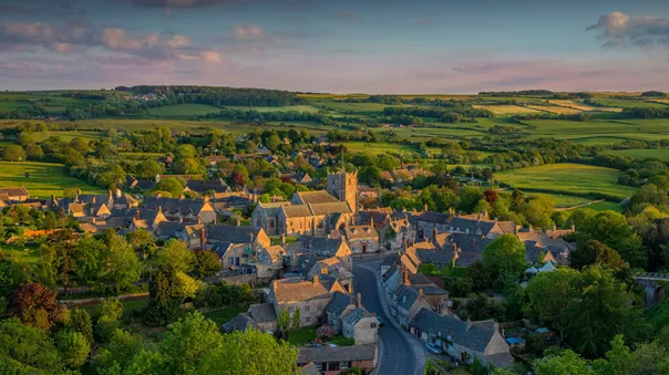 The traditional Corfe Village surrounded by fields in Dorset, England, UK