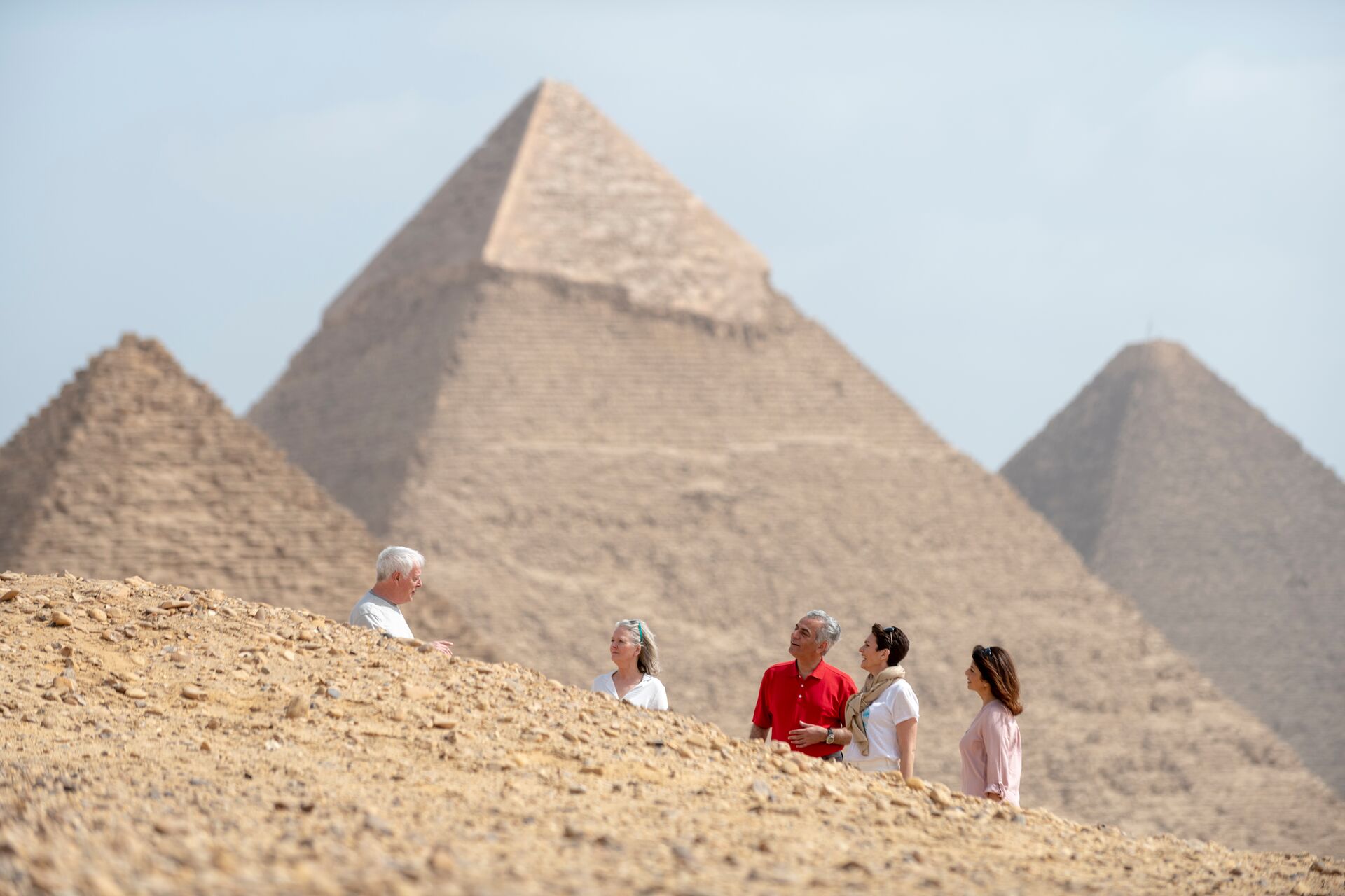 Guests talking to their Travel Director in front of the Pyramids in Giza, Egypt