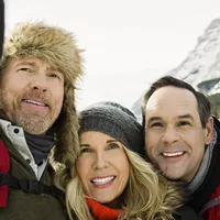 People taking a photo during winter in mountains.