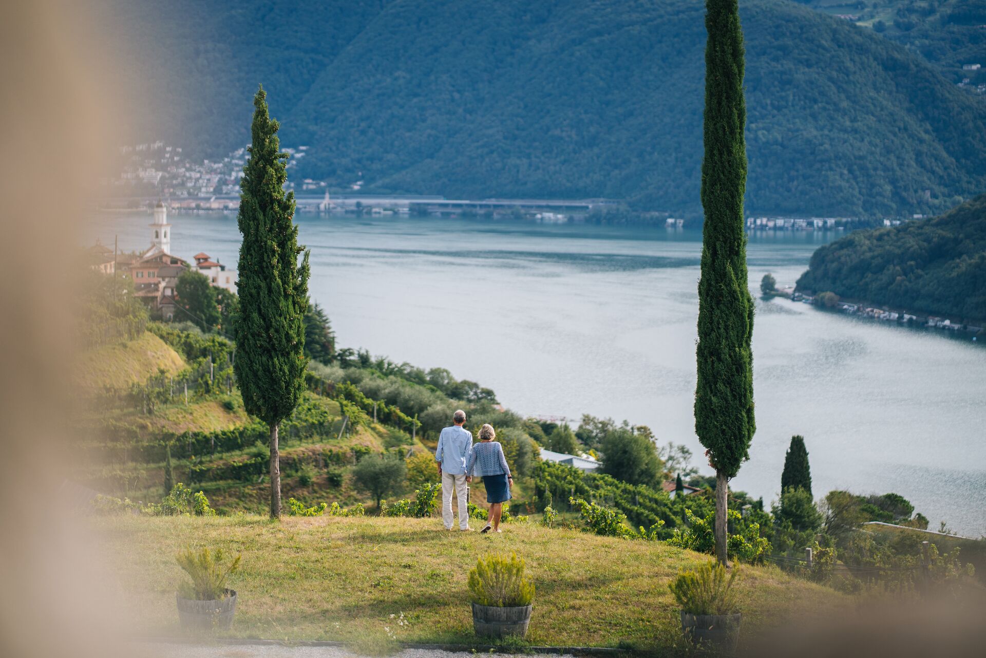 Couple walk through a vineyard in Switzerland in the morning