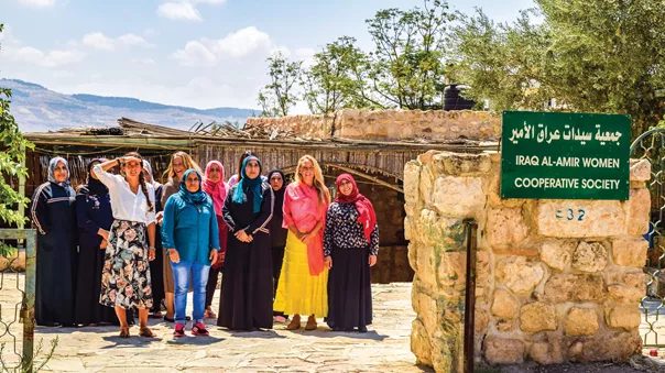 Women standing and smilling in Iraq