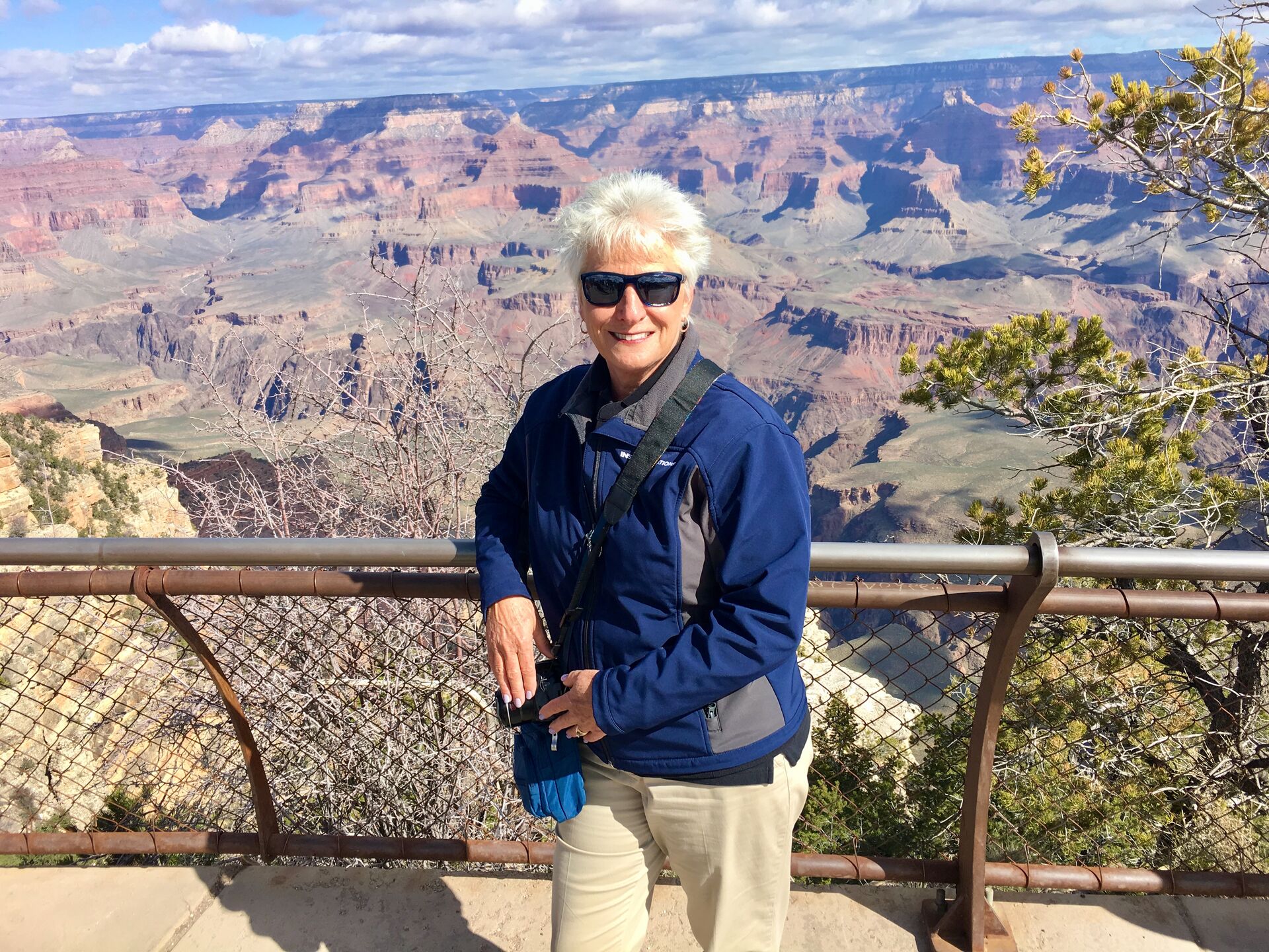 Travel Director Carol standing at a viewing point at the Grand Canyon.